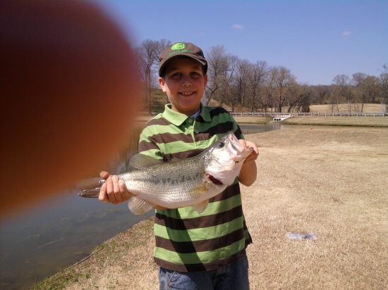 Jacob, who was ten years old when he landed this 23 inch largemouth bass on a four inch slider worm.  His excited dad's finger almost ruined his picture.