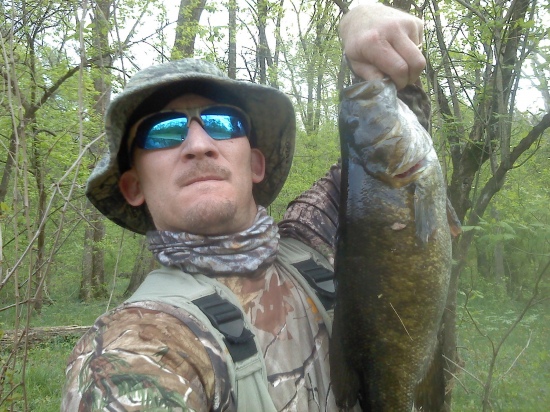 This smallmouth bass was caught in the spring of 2012 from the Neshaminy Creek in Bucks County PA. This is a small stream: riffles, runs, and pools. Average depth 2-4 feet, but some sections just ankle deep. Fishing overall for the day was terrible. This fish was caught at the end of the day. Good thing I tried a few more casts. The weight is just a guess at 3-4 lbs. Photo is a self portrait taken with my cell phone.