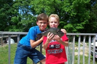 My boys, Jonathan (left) and Matthew (his fish) with the 31 oz. shellcracker caught from our pond on the farm in Louisburg, NC. I'm one proud poppa.