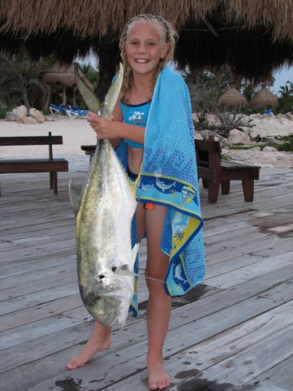 My daughter with a Jack I caught off of the beach last year in Cancun