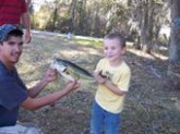 This is the bass my son caught at his 5th birthday party, and his uncle helping him to display it. My baby even kissed his fish before he released it!
