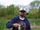 This is my son Johnny. We were fishing with shiners in a farm pond in Md. near Baltimore when this 3lb. 1 oz. largemouth hit.