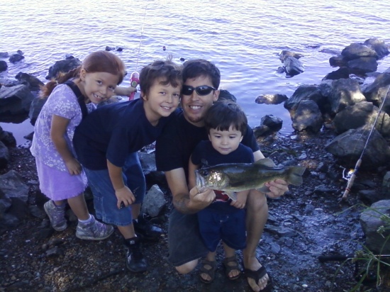 This is a photo of my husband Robert, son Javin, Son Robert jr, daughter Aiyana. Caught a bass in stockton,ca delta. It was about a four pound fish.