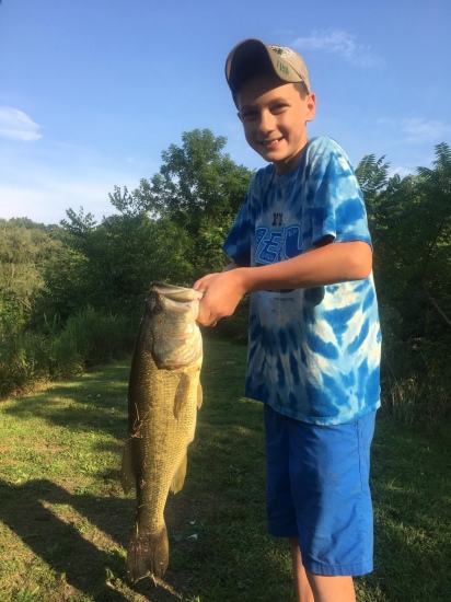 This is my son Charlie his first large mouth bass out of a private stripper cut in north east ohio.