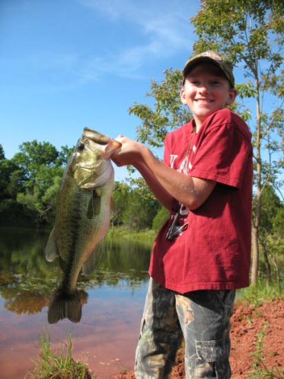 Caleb caught this seven pounder on a soft plastic shad, pearl white, out of an Oklahoma farm pond.