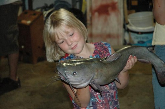 my cousin jayme holding a nice 9.lb catfish i caught on a farm pond in blue grass, iowa