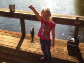 this is paislee holding a largemouth bass caught in a pond in webb alabama