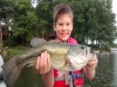 this my grandson carson,this is his first largemouth bass,caught on lake camelot mapleton illinois ,it's weight was 2.4 lbs. carson let him go.