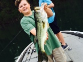 Cy Casey fishing with his cousin and Papa at Clark Hill shows his 5 lb. bass he caught on a jig.