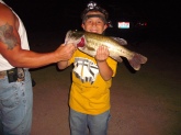 This was a night ill never forget. It was my dad,my son and me. My son  dakota just got done playin a baseball game,and after after the game he came over to me and said can we go fishin tonight dad? Of course i said yes. it was dark by time we got out to the pond, I tied him on a pop-r pearl white.hopin he would catch his first bass! well he did he caught 4 that night!! i was so proud of him. in this picture he is holdin a bass I caught bout a foot off the bank.I had on a black buzz bait and he blew it up!! it weighed 5 lbs  caught in coshocton ohio at 9 30 pm. It was a great night!!!